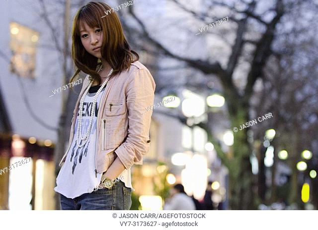 Japanese Girl poses on the street in Jiyugaoka, Japan. Jiyugaoka is a town located in Tokyo