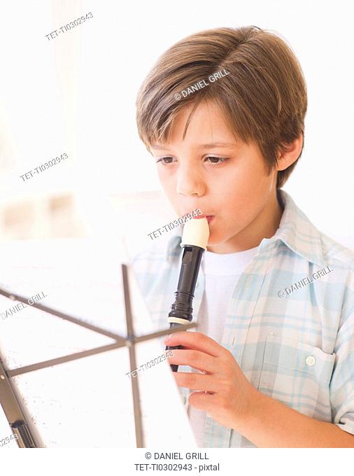 Boy 10-11 years playing flute