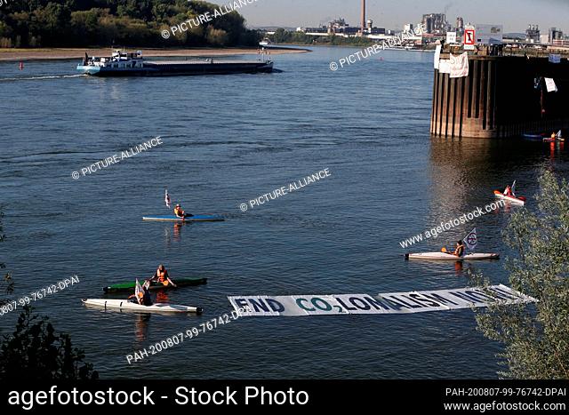 07 August 2020, North Rhine-Westphalia, Cologne: Environmental activists block with kayaks the port access road to the Shell refinery Wesseling in the Godorf...