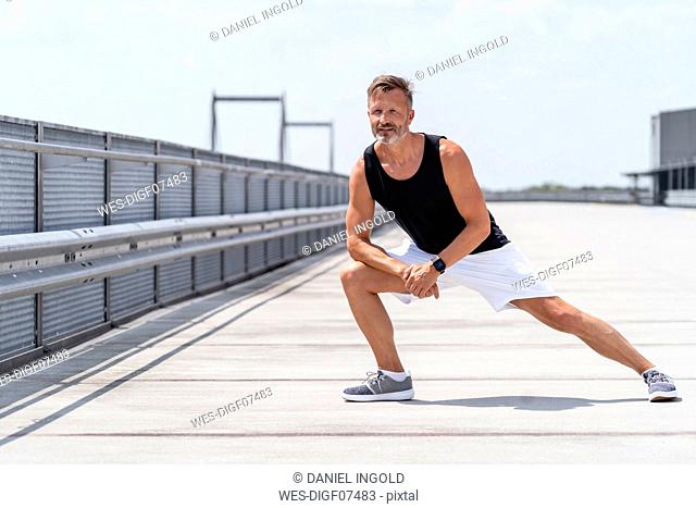Sporty man stretching outside