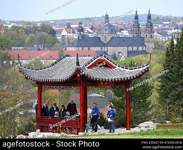27 April 2023, Hesse, Fulda: A guided group stands in the cultural garden of the State Horticultural Show at a Chinese temple