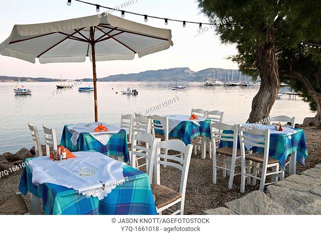 Table and chairs on the waterfront at sunset, Adamas, Milos Island, Dodecanese, Greece