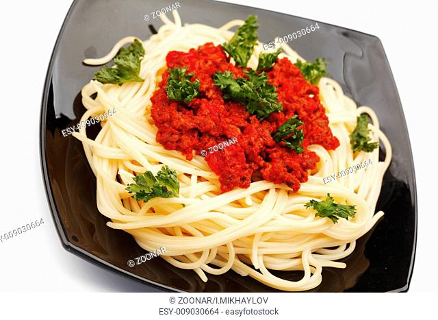 Spaghetti bolognese on black plate