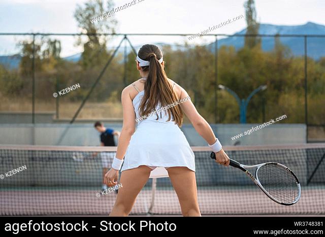 Woman playing Tennis on court