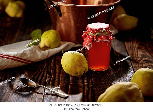 Quince jelly and fruit on wooden table