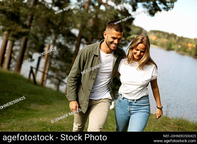 Smiling couple walking at lake