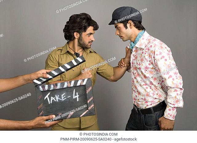 Actors portraying Gabbar Singh and Dev Anand on a movie set