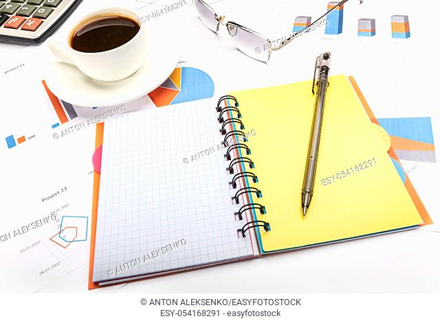 Notepad with a pen, coffee and papers business concept