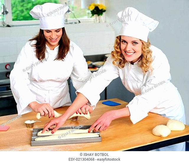 Female chef arranging prepared dough