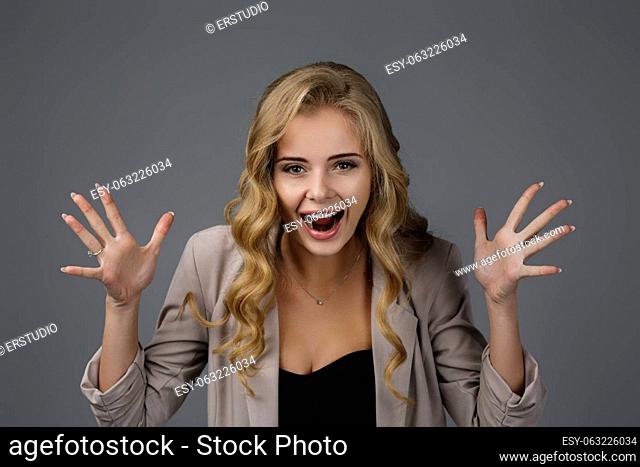 Portrait of young surprised beautiful business woman with shocked facial expression