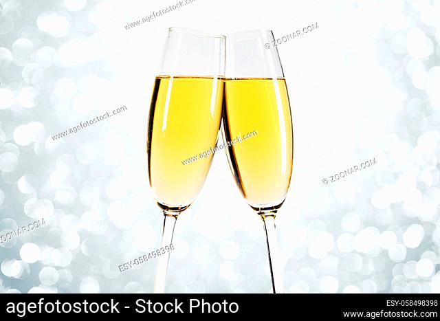 Two glasses of champagne with bokeh lights in the background New Year party celebration concept