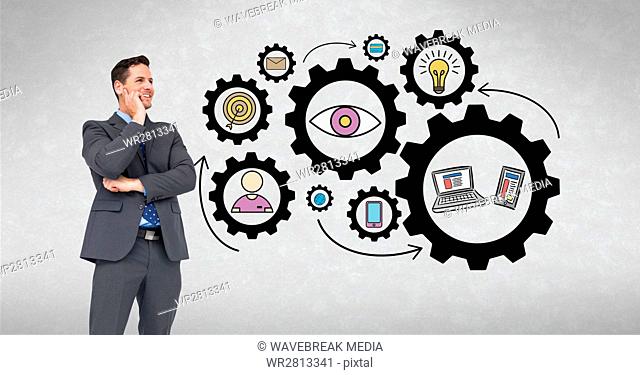 Digital composite image of happy businessman looking at gears and icons