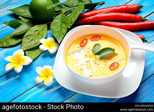 Thai spicy pumpkin and coconut milk soup with kaffir lime leaves , red chilli and galangal roots powder. Vegan, healthy food, gluten-free. Paleo- diet