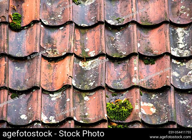 Old and ruined roof tiles close-up. Texture of a roof with old roof tiles. abstract background texture