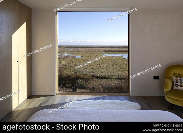 Interior view of bedroom and view of Nature reserve. Druim, Winchlesea, United Kingdom. Architect: RX Architects, 2020