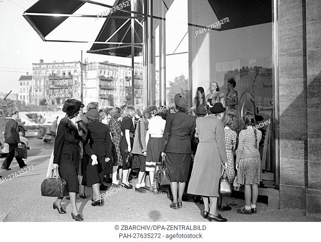 Women are jostling in front of the shopping windows of the Kaufhaus des Westens (KaDeWe, mall of the west), on Tauentzienstraße in West Berlin, pictured in 1950