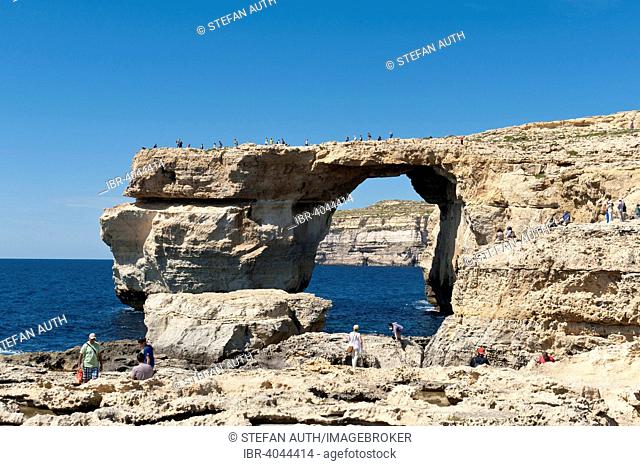 Natural arch made of a limestone known as Lower Corallian, on the coast, tourists, Azure Window, Dwejra Point, West Coast, Gozo, Malta