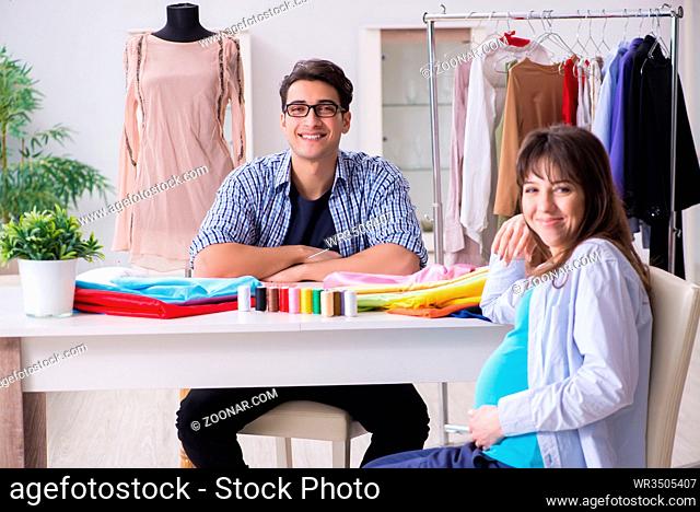 Pregnant woman visiting tailor for new clothing