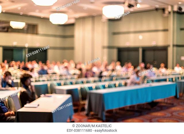 Blured image of audience in conference hall attending business conference