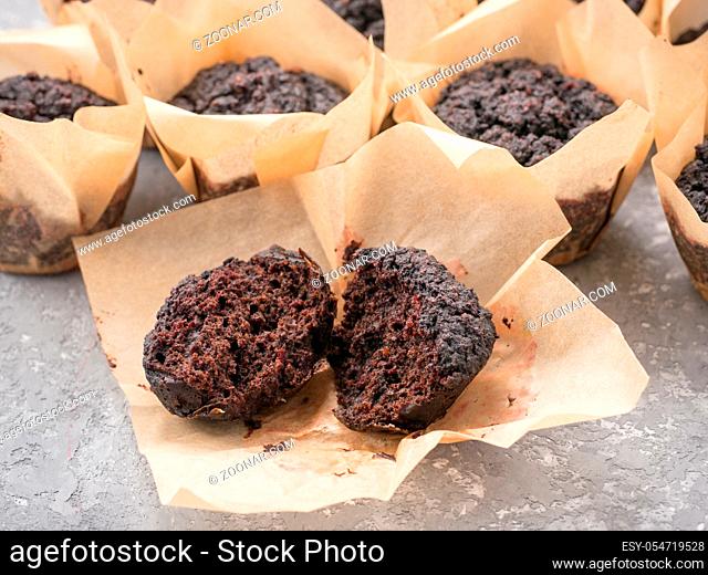 Gluten-free vegan chocolate muffins with beetroot, almond powder, buckwheat flour and karob or cocoa . Homemade cupcakes on gray concrete background with...