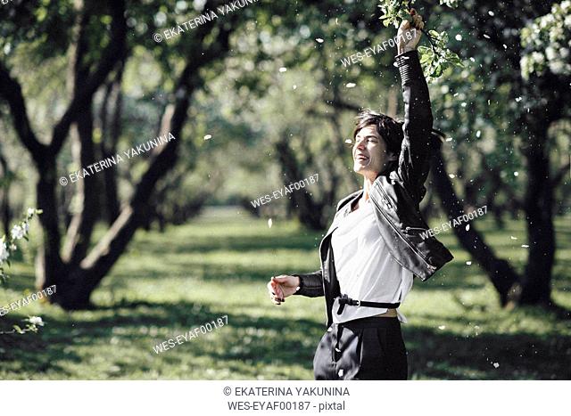 Happy woman enjoying blossoming season