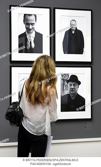 A young woman looks at photos by photographer Mart Engelen in the three-part exhibition 'Alice Springs: The MEP Show, Helmut Newton: Yellow Press