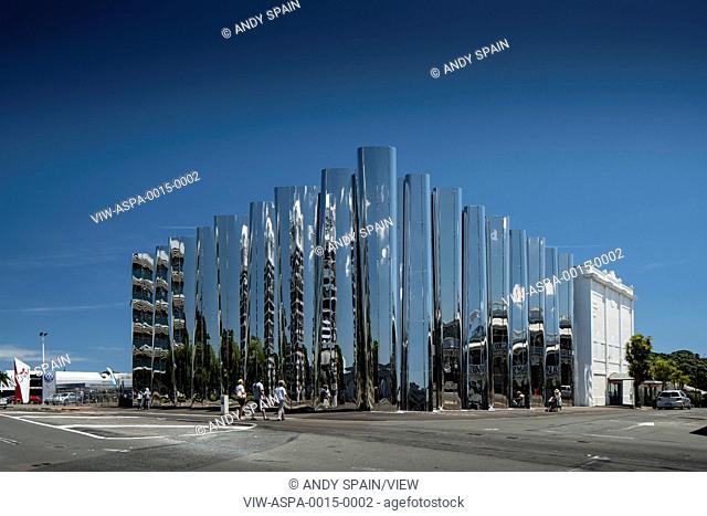 Corner view across street towards polished building facade with existing Govett Brewster Art Gallery. Len Lye Centre, New Plymouth, New Zealand