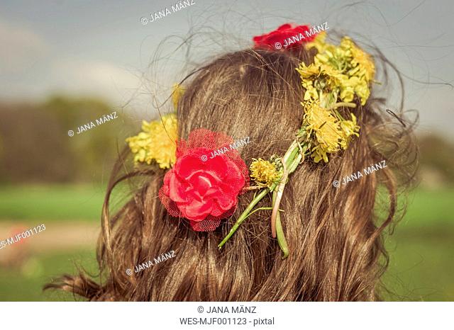 Head of little girl wearing flowers, back view