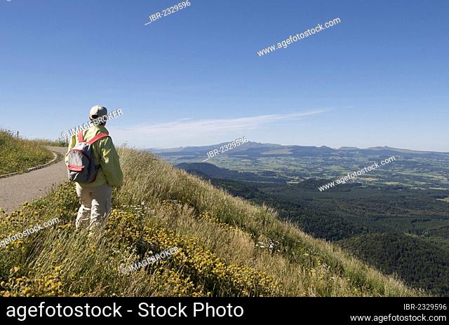 Hiker looking at the Massif of Sancy, Auvergne, France, Europe