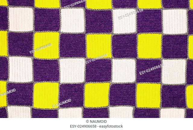 Homemade knitted fabric in a patchwork style texture background