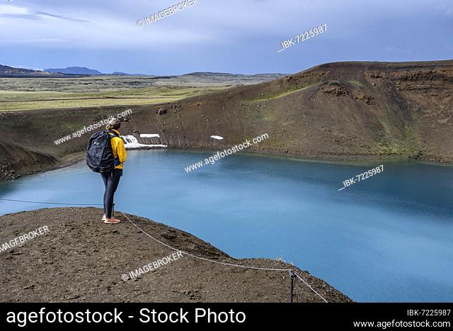 Tourist, volcanic lake, crater lake Viti at the central volcano Krafla, Myvatn, North Iceland, Iceland, Europe