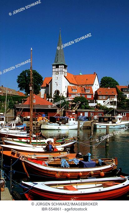 Boats in the harbor of Roenne in front of the Nicolaichurch, Bornholm, Denmark