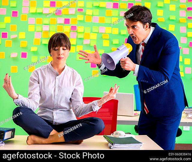 Man and woman in the office with many conflicting priorities in yoga concept