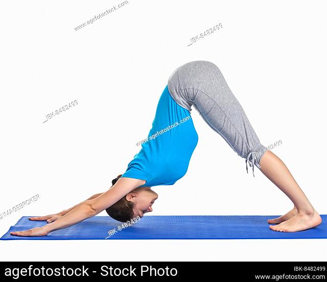 Yoga, young beautiful woman yoga instructor doing downward facing dog pose (adho mukha svanasana) exercise isolated on white background