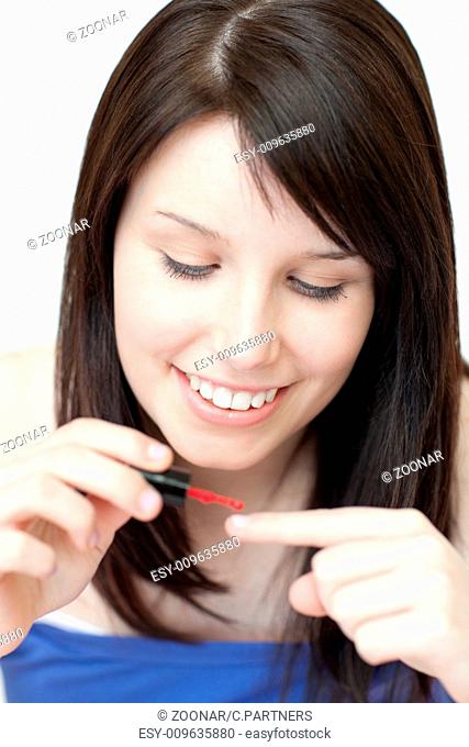 Attractive woman painting her nails