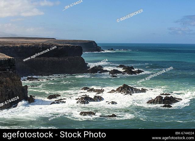 Cliff with rocks in the sea, near Playa de Esquinzo, near Taca west of La Oliva, Fuerteventura, Atlantic Ocean, Canary Islands, Spain, Europe