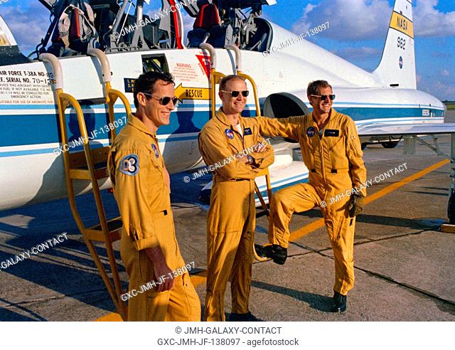 The prime crewmen of the third manned Skylab mission (Skylab 4) pause at a USAF T-38A jet at Ellington Air Force Base, Texas before flying to Kennedy Space...