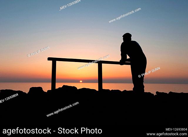 Bronze statue of fisherman watching the sunset, Port William, Wigtownshire, Dumfries and Galloway, SW Scotland overlooking Luce Bay