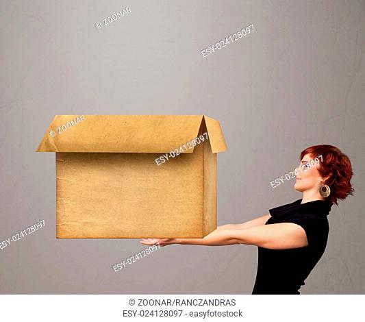 Young woman holding an empty cardboard box