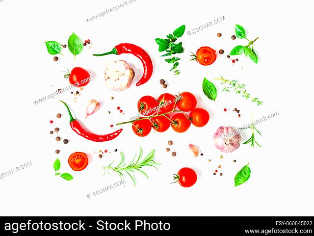 Top view of cherry tomatoes and green herbs with spices isolated on white. Italian cuisine, food art