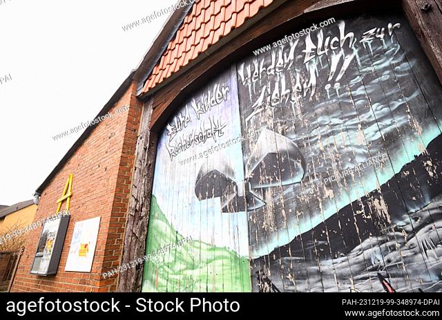 19 December 2023, Lower Saxony, Salzgitter: A graffiti with the words ""Your children will hold you accountable"" and a nuclear sign can be seen on a barn in...