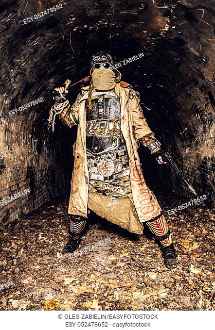 Survived in nuclear disaster and living in catacombs or city underground tunnels human creature, wearing rags and handmade lamellar body armor