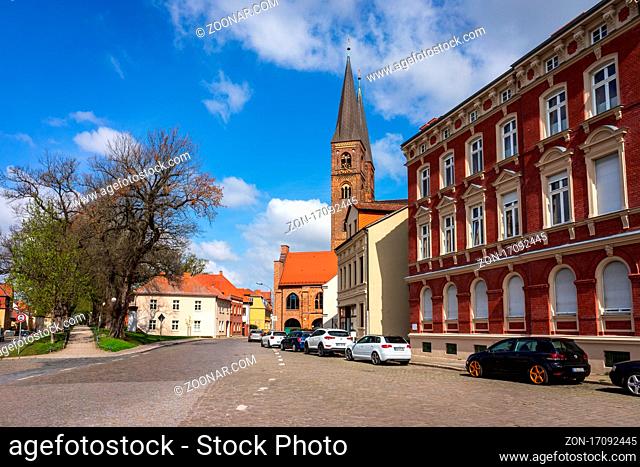 STENDAL, GERMANY - APRIL 24, 2021: Houses and buildings on the streets in the old town. In the background St. Nicholas Church