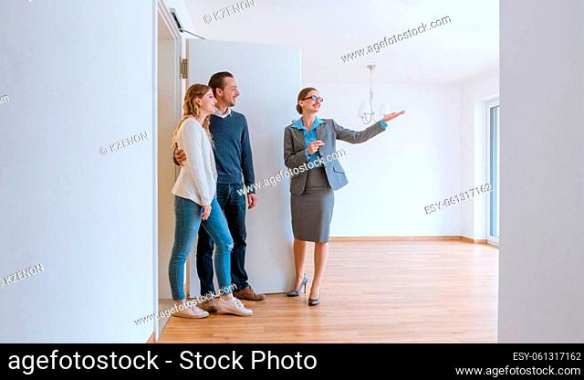 Realtor showing house to a young couple wanting to rent it