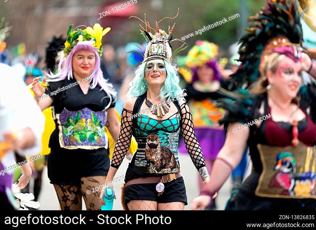 New Orleans, Louisiana, USA - February 23, 2019: Mardi Gras Parade, Members of The Dames De Perlage, Wearing colorful outfits walking down the street at the...