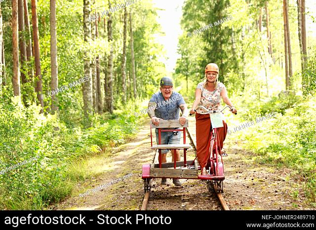 Couple riding handcar