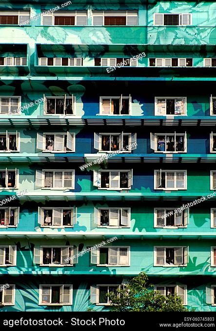 Group of windows at facade building in green on day, this highrise building is student dormitory at Ho Chi Minh city, Vietnam