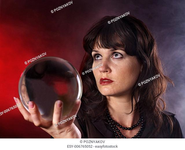Young woman with crystal ball. Beauty and fashion