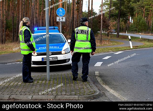07 February 2020, Brandenburg, Grünheide: Police officers are blocking a road next to the site of the future Tesla factory