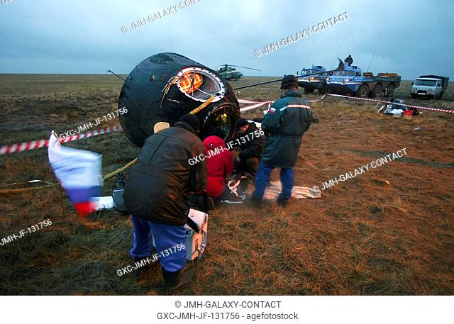 The Soyuz capsule lies on its side after landing approximately 85 kilometers northeast of Arkalyk in northern Kazakhstan with astronaut Edward M